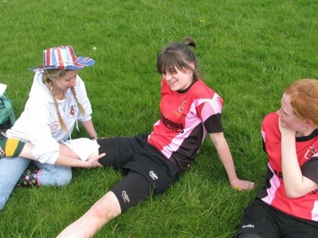 Kirstie administering first aid during a girls rugby tournament in the late 2000’s.
